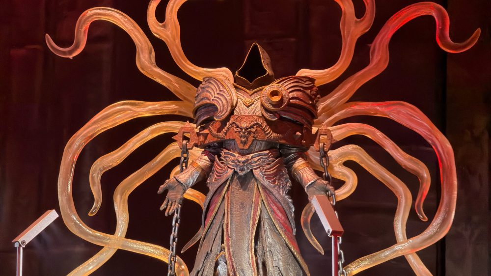 A fantasy statue representing a robed figure with a hood and intricate armor, featuring large, stylized tentacle-like appendages surrounding it.