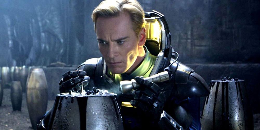 A close-up of a man in a futuristic suit, intently examining a mysterious object in a dark, cavernous environment.