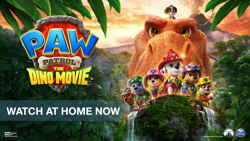 Promotional image for 'PAW Patrol: The Dino Movie' featuring the main characters in a lush, green jungle setting with a dinosaur in the background. Text reads 'WATCH AT HOME NOW'.